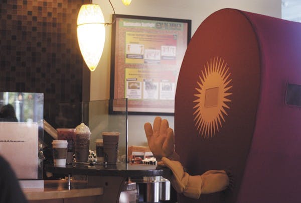 Markie the mascot stops by the Starbucks counter in the MU to greet the baristas and other students nearby. He was walking around campus on Friday afternoon to promote on Mark-It Day March 7th. (Photo by Perla Farais)
