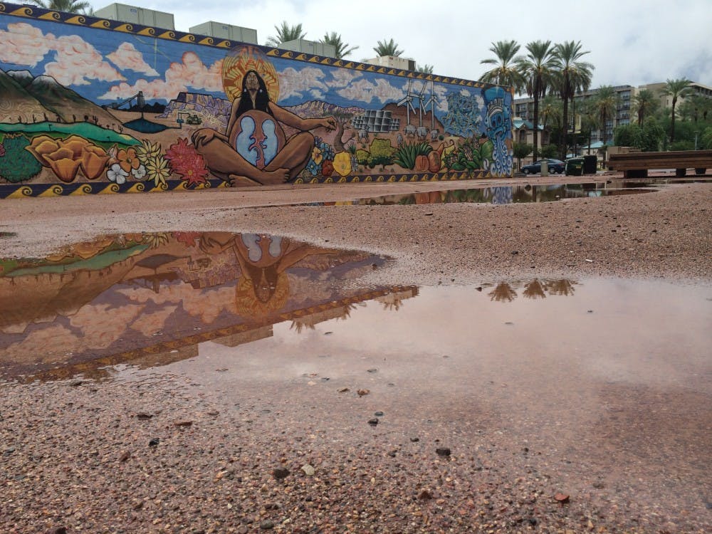 Flooding had subsided to puddles near the Valley Youth Theatre in Phoenix by midday. (Photo by Fabian Ardaya)