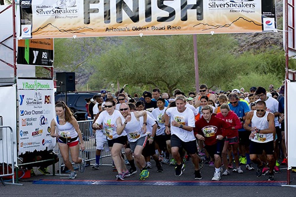 John Hetrick, 46, (third from left) leaves the starting gate in the 5K race at Y Race Phoenix at South Mountain Park in Phoenix, Ariz., on Sunday, Oct. 20, 2013. Hetrick's final time was 18:48. (Photo by Caitlin Cruz)