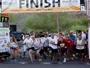 John Hetrick, 46, (third from left) leaves the starting gate in the 5K race at Y Race Phoenix at South Mountain Park in Phoenix, Ariz., on Sunday, Oct. 20, 2013. Hetrick's final time was 18:48. (Photo by Caitlin Cruz)