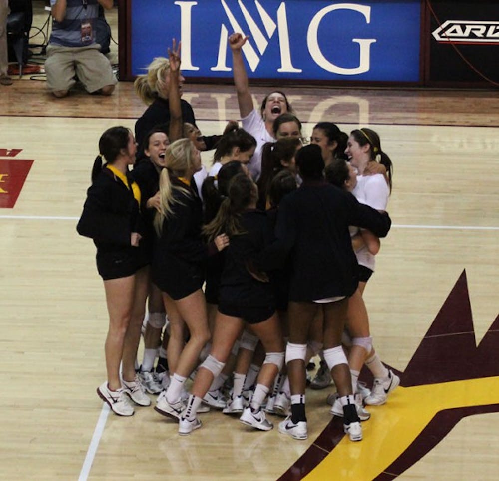 The ASU volleyball team celebrates after a 3-0 sweep of No. 6 USC on Nov. 2. (Photo by Kyle Newman)