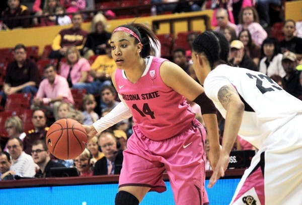 Junior guard Adrianne Thomas scans the floor setting up a play for the Sun Devils against Colorado on Feb. 17. Thomas had to assume a huge leadership role this season after starting senior point guard Deja Mann was injured for the season. (Photo by Dominic Valente)