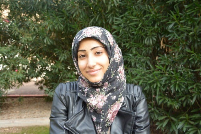 Interior design major Areej Al-dar sits next to the Matthews Center, patiently waiting for class to start. (Ryan Santistevan/The State Press)