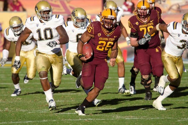 Title game awaits: ASU junior running back Cameron Marshall eludes UCLA defenders during the Sun Devils’ win in November. Both ASU and the Bruins will both play in the Pac-12 South this season for the chance to play in the inaugural conference championship game. (Photo by Aaron Lavinsky)