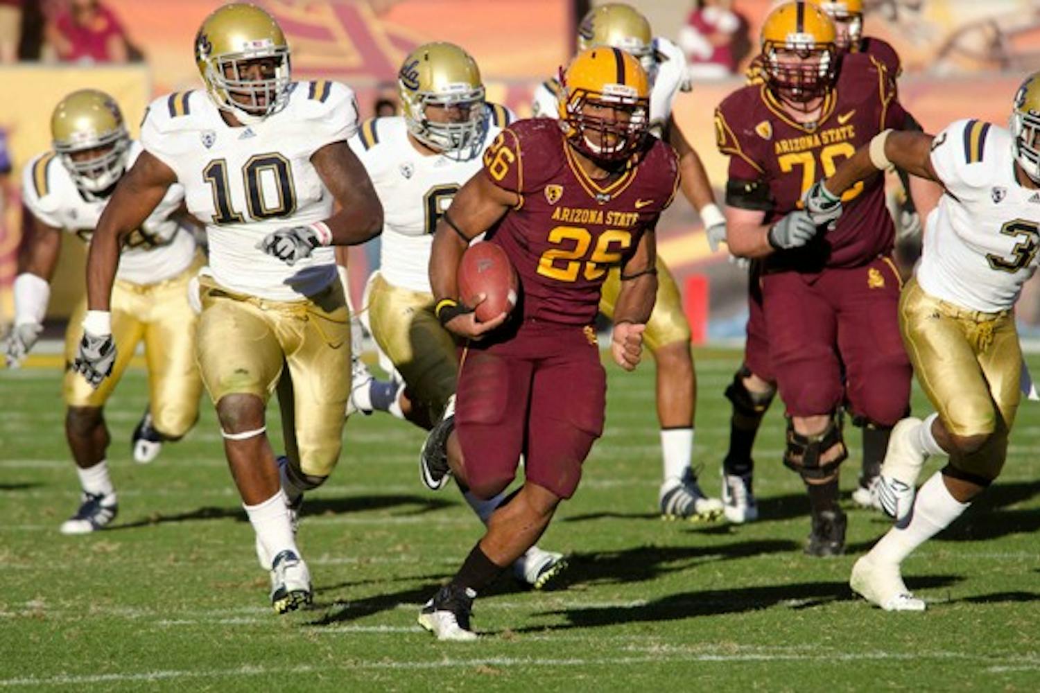 Title game awaits: ASU junior running back Cameron Marshall eludes UCLA defenders during the Sun Devils’ win in November. Both ASU and the Bruins will both play in the Pac-12 South this season for the chance to play in the inaugural conference championship game. (Photo by Aaron Lavinsky)