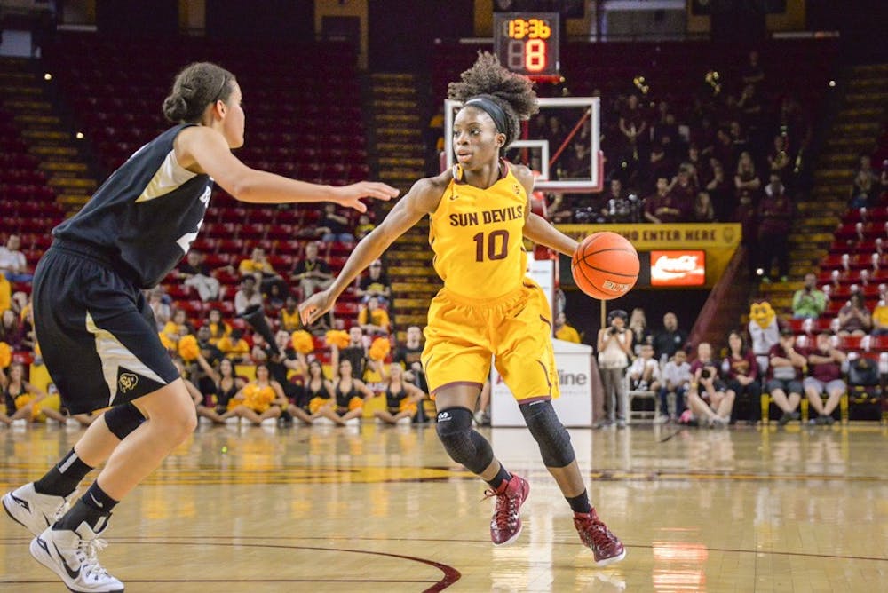 ASU senior Promise Amukamara looks around the Colorado defender to make the pass during the last game of regular season play. The Sun Devils would go on to their 26th game of the season with today's win over Colorado on March 1, 2015, at the Wells Fargo Arena in Tempe. (J. Bauer-Leffler/The State Press)