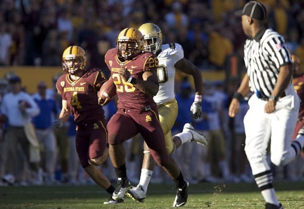 Breakaway: ASU sophomore Cameron Marshall sprints away from the UCLA defenders during the teams 55-34 victory over the Bruins. Marshall finished with 148 yards in the game, including a 71-yard touchdown run. (Photo by Scott Stuk)