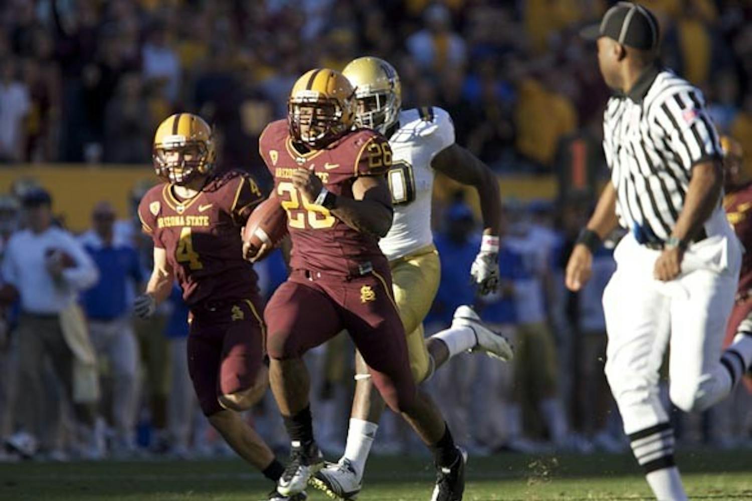 Breakaway: ASU sophomore Cameron Marshall sprints away from the UCLA defenders during the teams 55-34 victory over the Bruins. Marshall finished with 148 yards in the game, including a 71-yard touchdown run. (Photo by Scott Stuk)