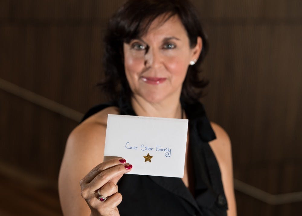 Natalie June Reilly, a 2013 ASU Communications graduate and former ASU staff member, sits with some of the hundreds of handwritten anonymous Thank You letters that she writes and gives to veterans, current service members, Gold Star Families and law enforcement members thanking them for their service.