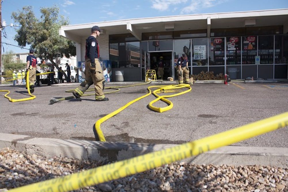 DOUSING FLAMES: Emergency crews responded to a fire at a Circle K store near Lemon Street and Rural Road Monday afternoon. There were no injuries. (Photo by Shawn Raymundo)