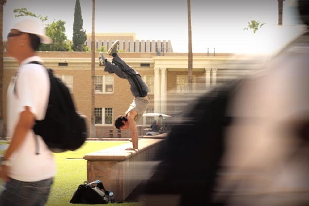 HANING IN THE BALANCE: Justin Martinez finds a unique way to balance himself for the new school year. (Photo by Andy Jeffreys)