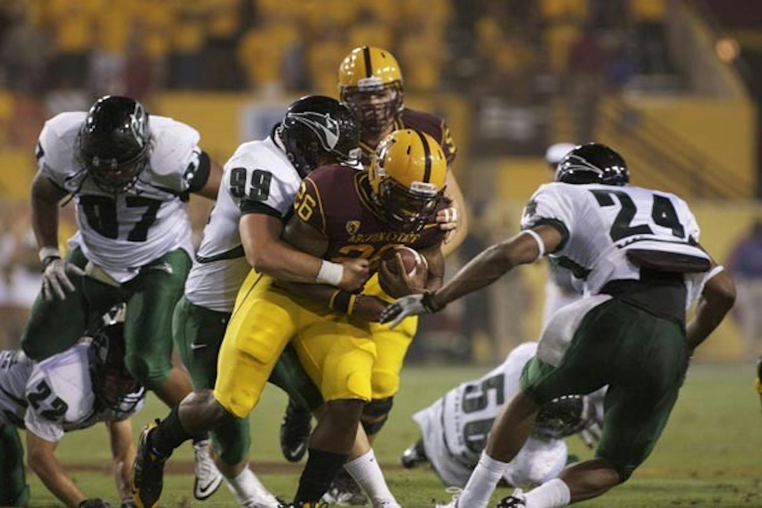 HEAVY LOAD: Sophomore running back Cameron Marshall is taken down by Portland State defenders in ASU's first game of the season. The Sun Devils hope Marshall can help match Oregon's speedy ground game. (Photo by Scott Stuk)