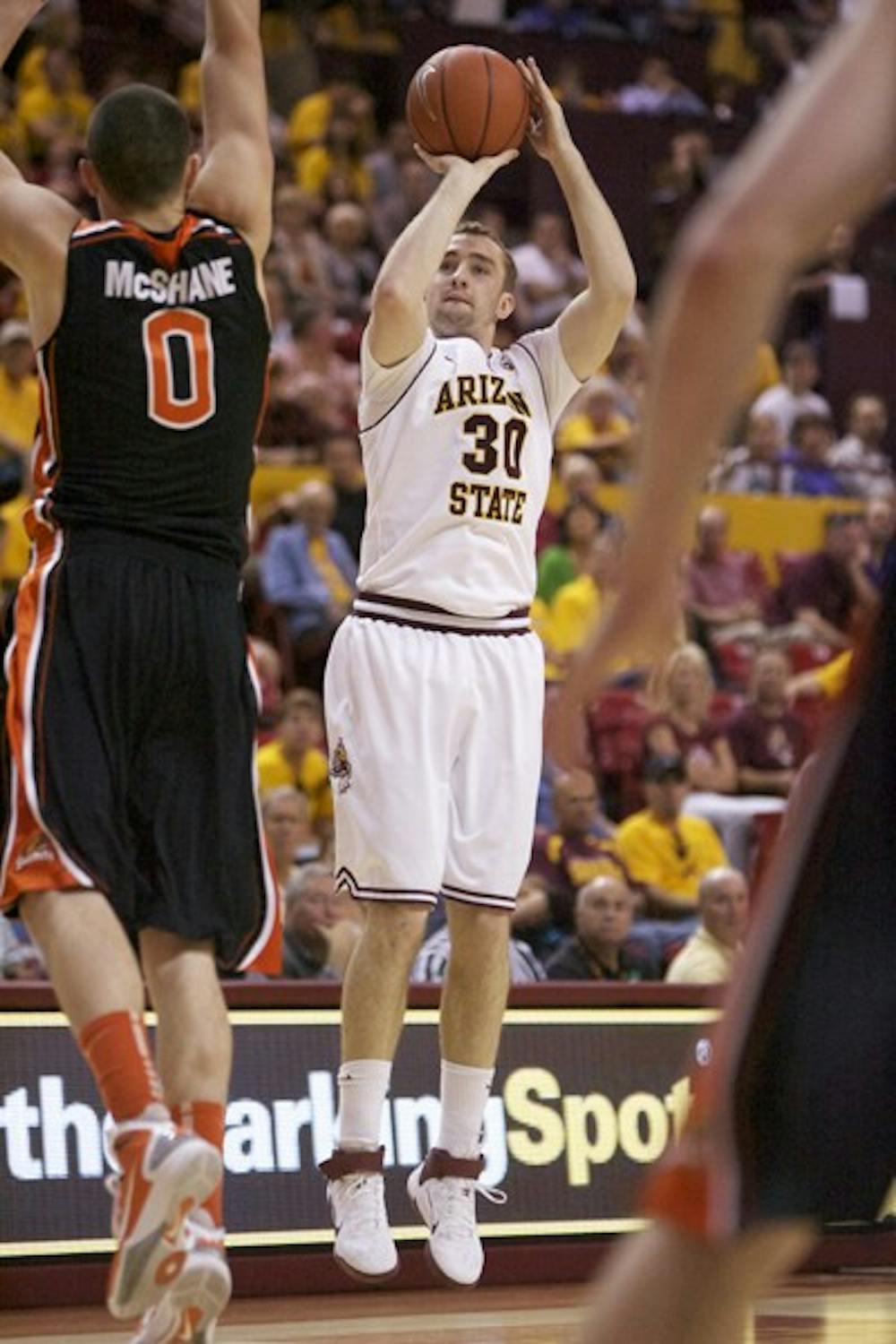 Favorable momentum: ASU senior guard Rihards Kuksiks shoots over Oregon State redshirt junior forward Kevin McShane during the Sun Devils’ 80-66 victory over the Beavers on Saturday. ASU opens the first round against Oregon on Wednesday, the only Pac-10 team it swept this season. (Photo by Scott Stuk)