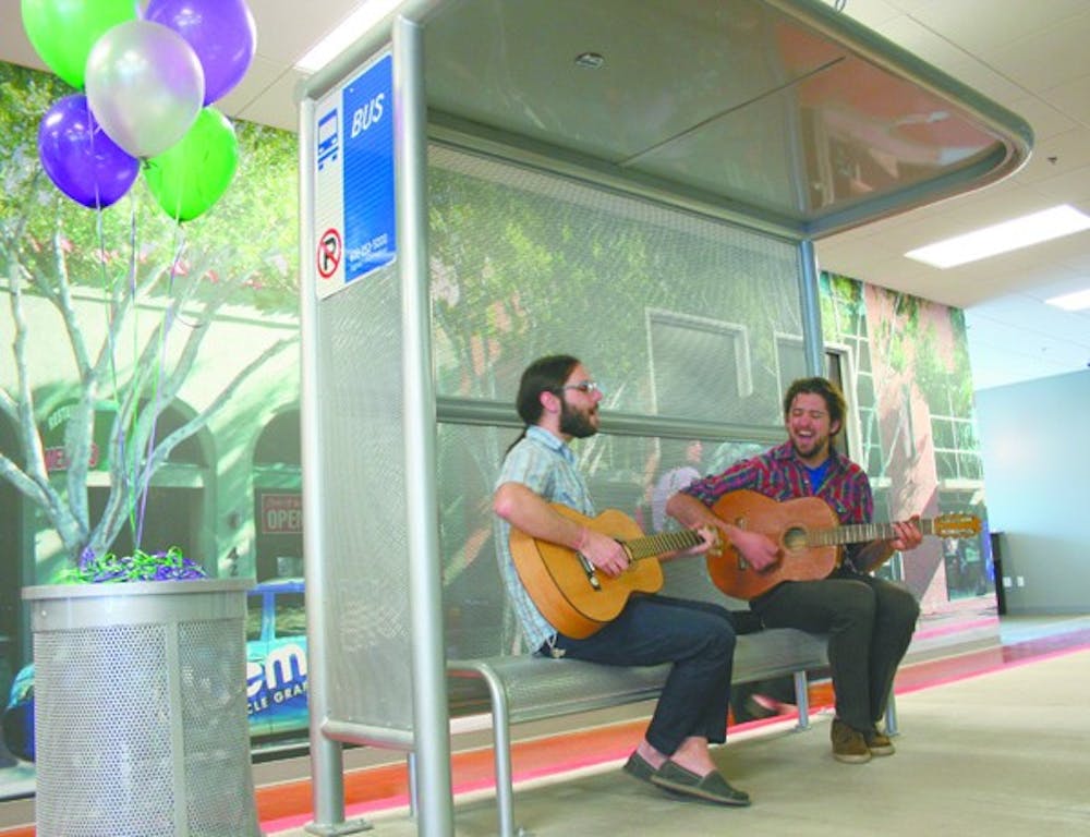 TRANSIT JAM: James Mulhern and Danny Godbold, Members from the local band "What Laura Says," play their song "How to Ride the Bus" at the grand opening of the Valley Metro Mobility Center on Wednesday night. (Photo by Lisa Bartoli)