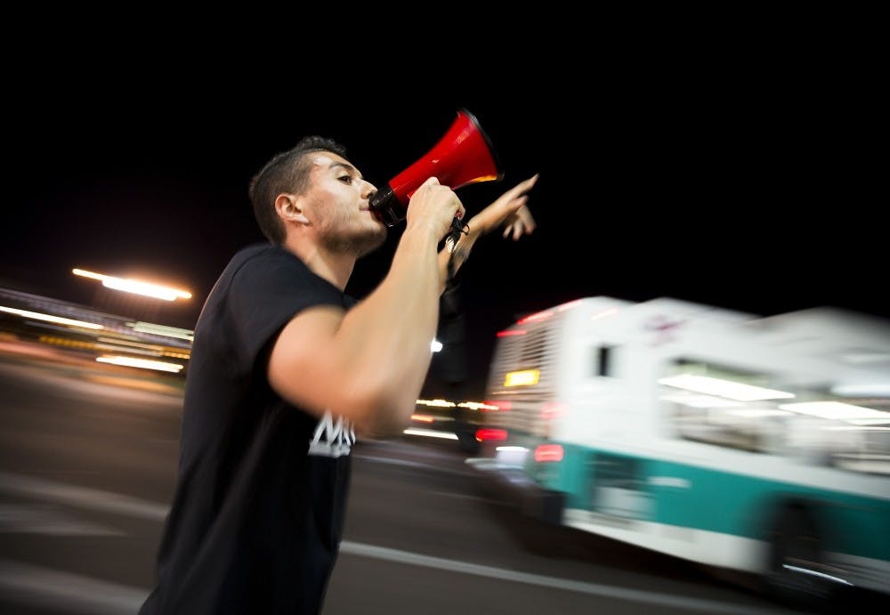 Organizer Randy Perez starts a chant during an election results protest on the ASU Tempe campus on Saturday, Nov. 12, 2016.