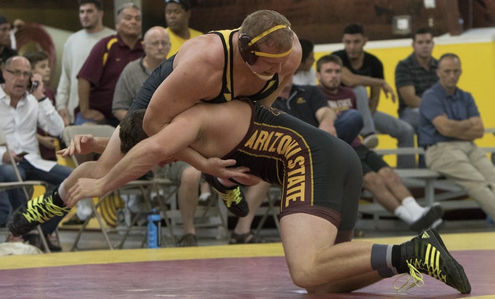 Freshmam Tanner Hall, right, competes against freshman Chace Eskam during an intrasquad match on Friday, Oct. 30, 2015, at Ritches Wrestling Complex in Tempe. Hall defeated Eskam 3-1. 