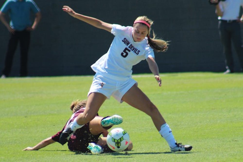 Junior midfielder Tommi Goodman wins a ball against an Aggie defender during ASU's game on Sunday Sept. 7. After an early goal by the Aggies, ASU scored one in each half to win 2-1. (Photo by Sawyer Hardebeck)