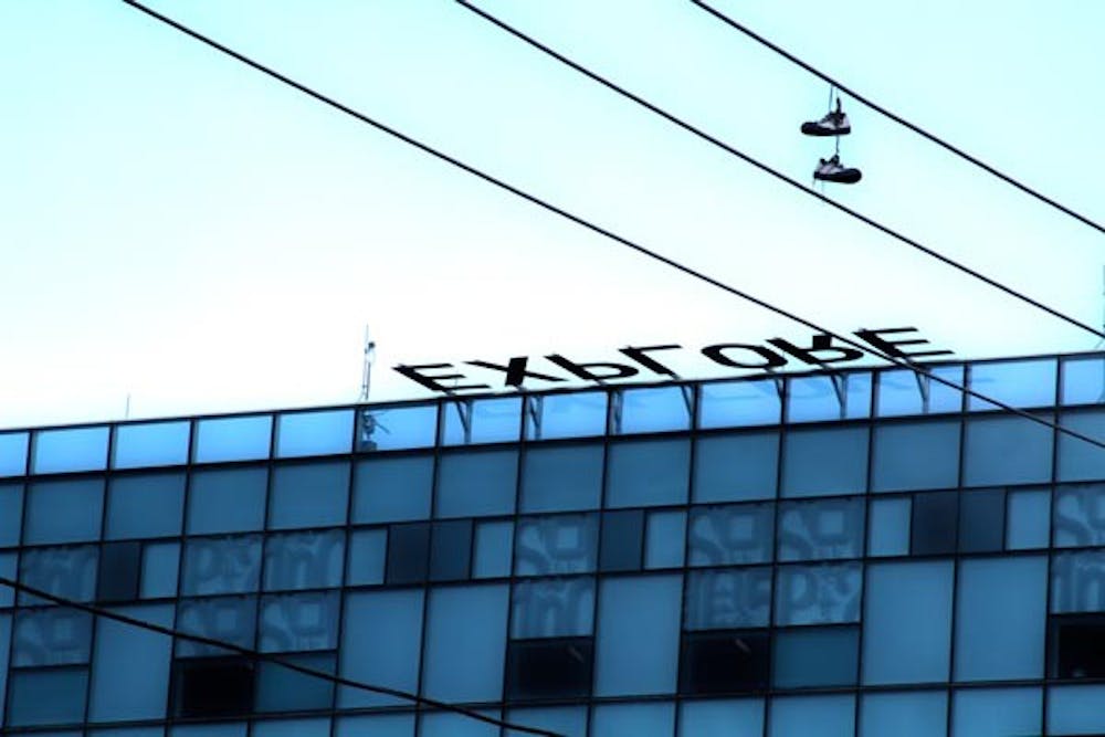 MELTING IN THE SUN: A pair of shoes hangs on a power line in front of the Lattie F. Coor Hall on the Tempe campus. (Photo by Andy Jeffreys)