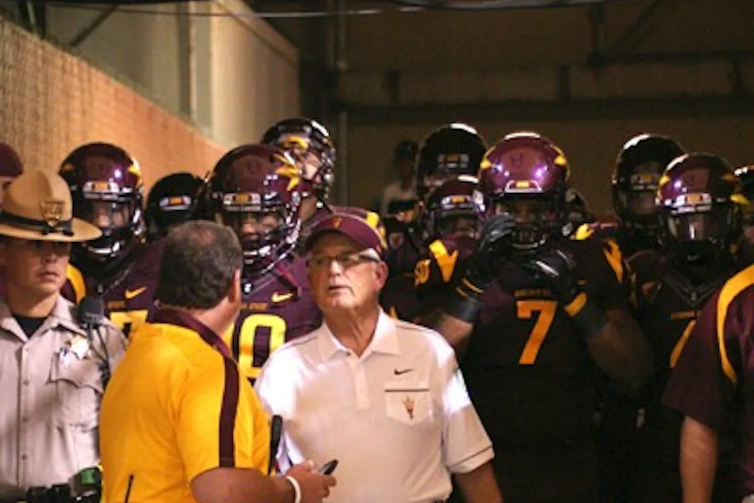 STILL THE LEADER: ASU coach Dennis Erickson leads the Sun Devil football team heading onto the field through the Pat Tillman Tunnel against USC on Sept. 24. Erickson said he remains focused for ASU’s rivalry game against UA on Saturday, despite hearing rumors regarding his job security. (Photo by Lisa Bartoli)