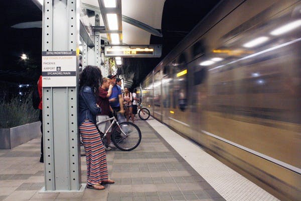 Students wait for the light rail Wednesday evening in Tempe. The Arizona Public Interest Research Group found that Generation Y is choosing to drive less and use public transportation instead. (Photo by Cameron Tattle)