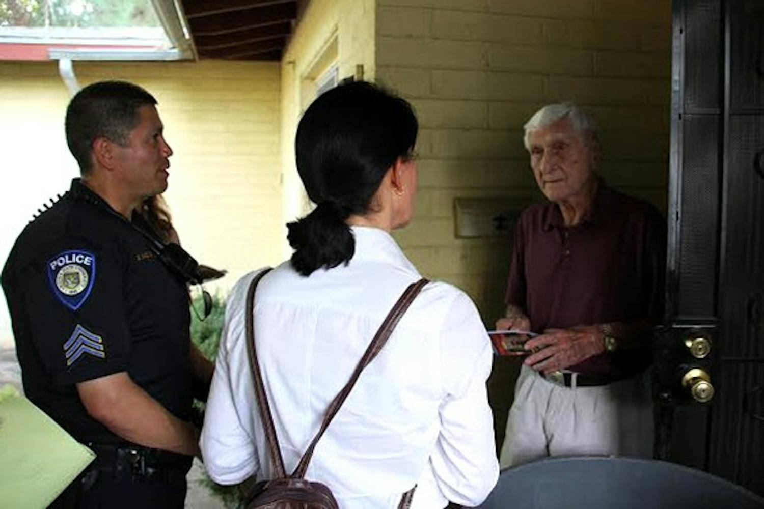 Tempe resident Jene Cornow talks to Julie Newberg, a member of ASU’s media relations team, and ASU Police Department Sargent Dan Macias about what is like to live in a neighborhood so close to a major university. (Photo by Peter Mare)