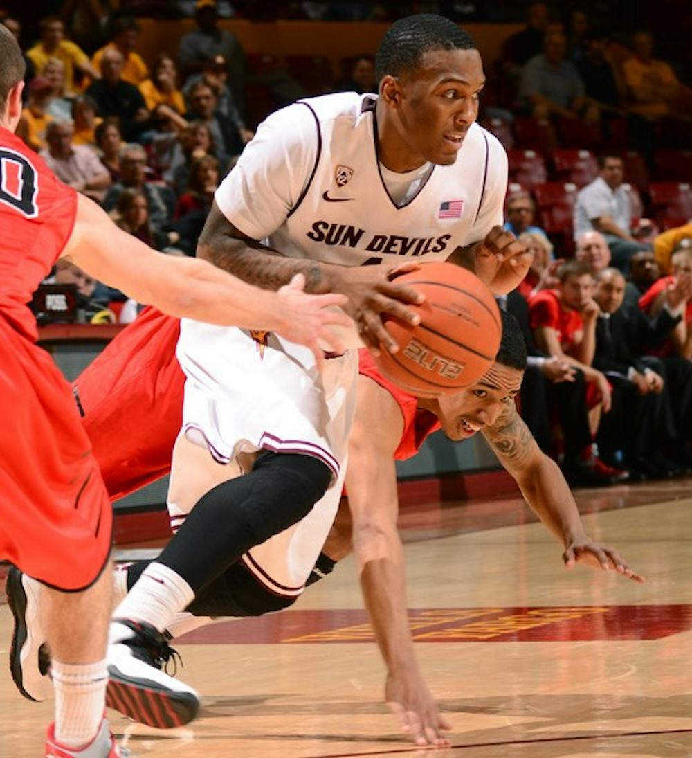 Redshirt freshman guard Jahii Carson splits two defenders during the Sun Devils’ 71-63 win over Hartford on Wednesday.
