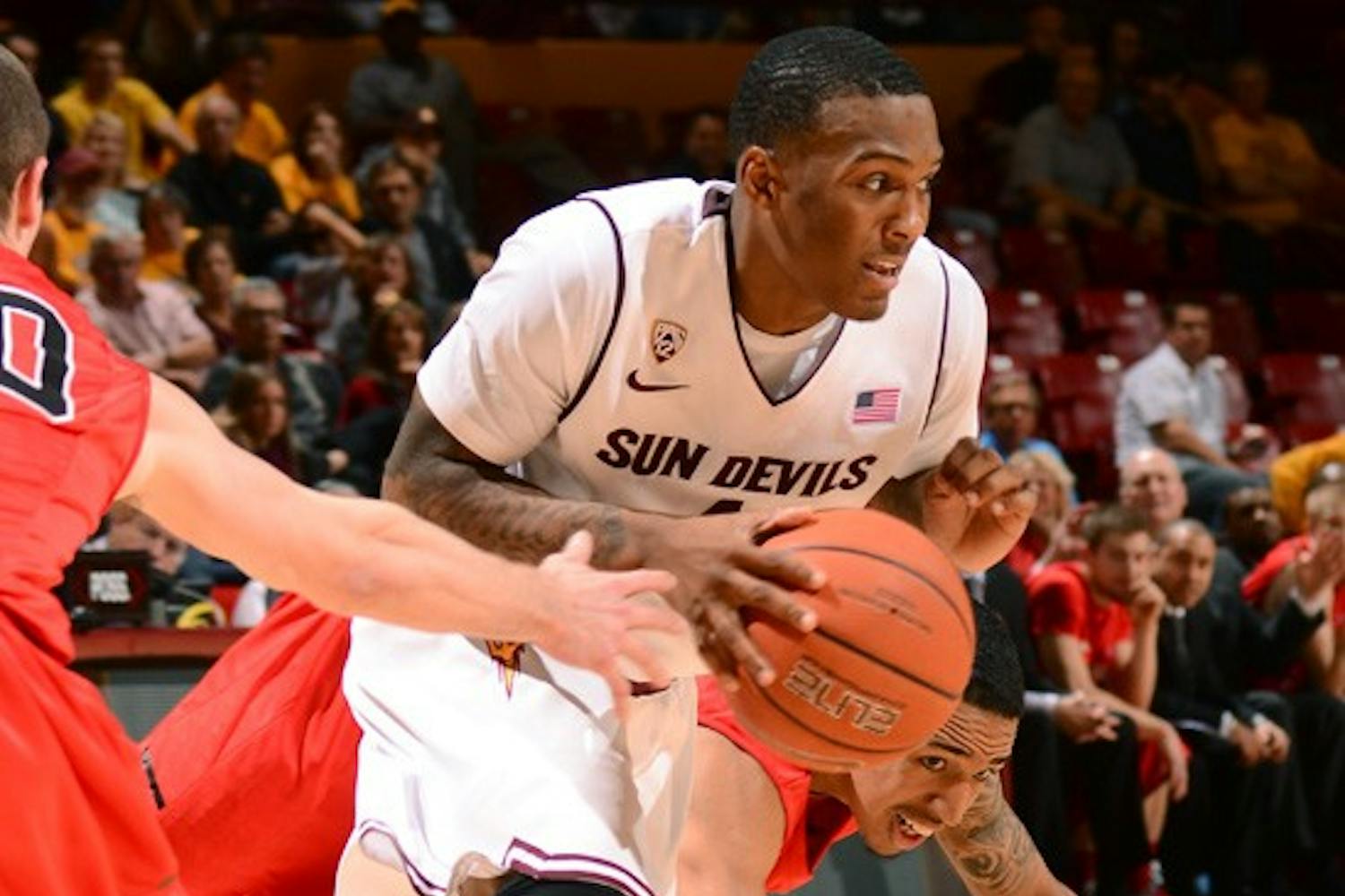 Redshirt freshman guard Jahii Carson splits two defenders during the Sun Devils’ 71-63 win over Hartford on Wednesday.
