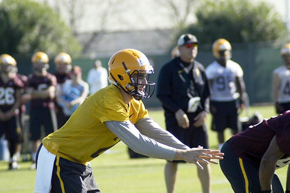 ASU redshirt senior quarterback Mike Bercovici calls for the snap during 11-on-11 drills at spring football practice in Tempe on March 17, 2015. (Fabian Ardaya/The State Press)