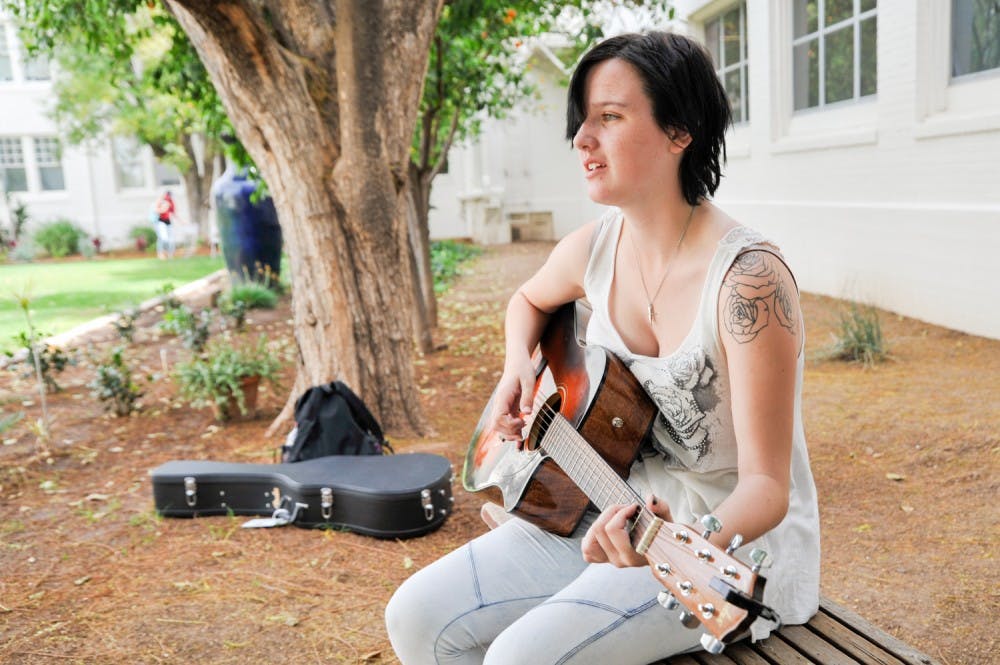 Grey  Leeseberg plays guitar and sings in the Secret Garden on the Tempe campus on Thursday, March 3, 2016.