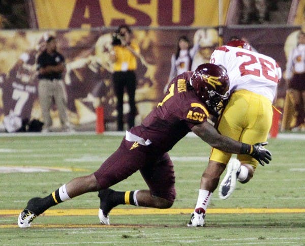 UNDER CONTROL: Junior linebacker Vontaze Burfict wraps up USC redshirt senior tailback Marc Tyler during the Sun Devils’ 43-22 win over the Trojans on Saturday. ASU appears to be the better team against Oregon State coming into Saturday’s matchup against the Beavers. (Photo by Beth Easterbrook)