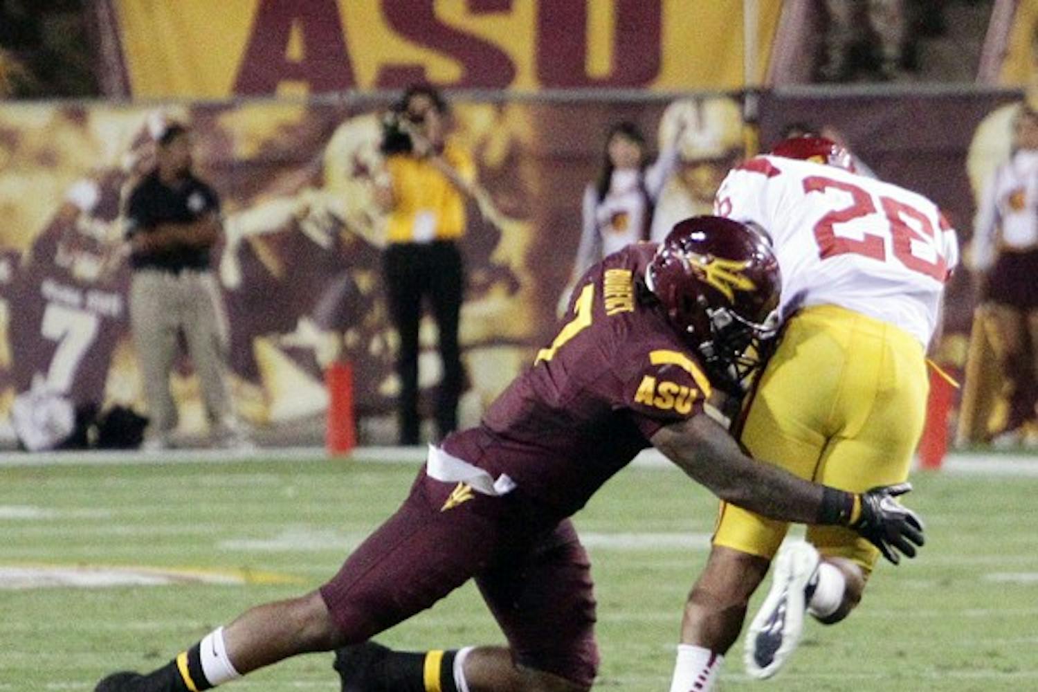 UNDER CONTROL: Junior linebacker Vontaze Burfict wraps up USC redshirt senior tailback Marc Tyler during the Sun Devils’ 43-22 win over the Trojans on Saturday. ASU appears to be the better team against Oregon State coming into Saturday’s matchup against the Beavers. (Photo by Beth Easterbrook)