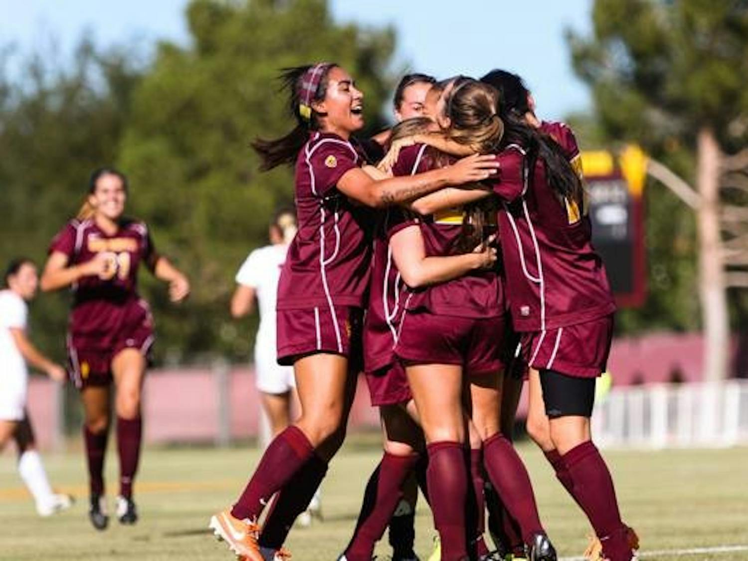 Members of the ASU women's soccer team celebrate a 1-0 win over UA that ultimately clinched the Sun Devils a playoff spot. (Photo by Daniel Kwon)
