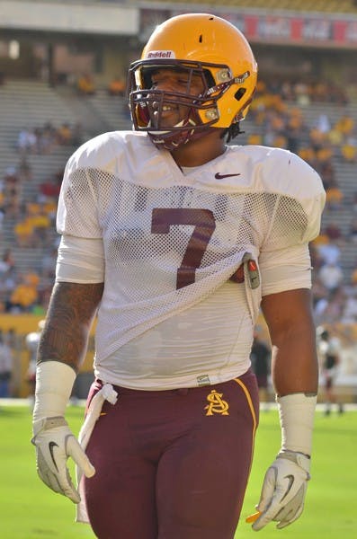 THE BIG HUSKY: Junior linebacker Vontaze Burfict smiles as he exits the field during a scrimmage in August. Burfict is one of six current Sun Devils who played football at Centennial High in Corona, Calif. under coach Matt Logan.  (Photo by Aaron Lavinsky)