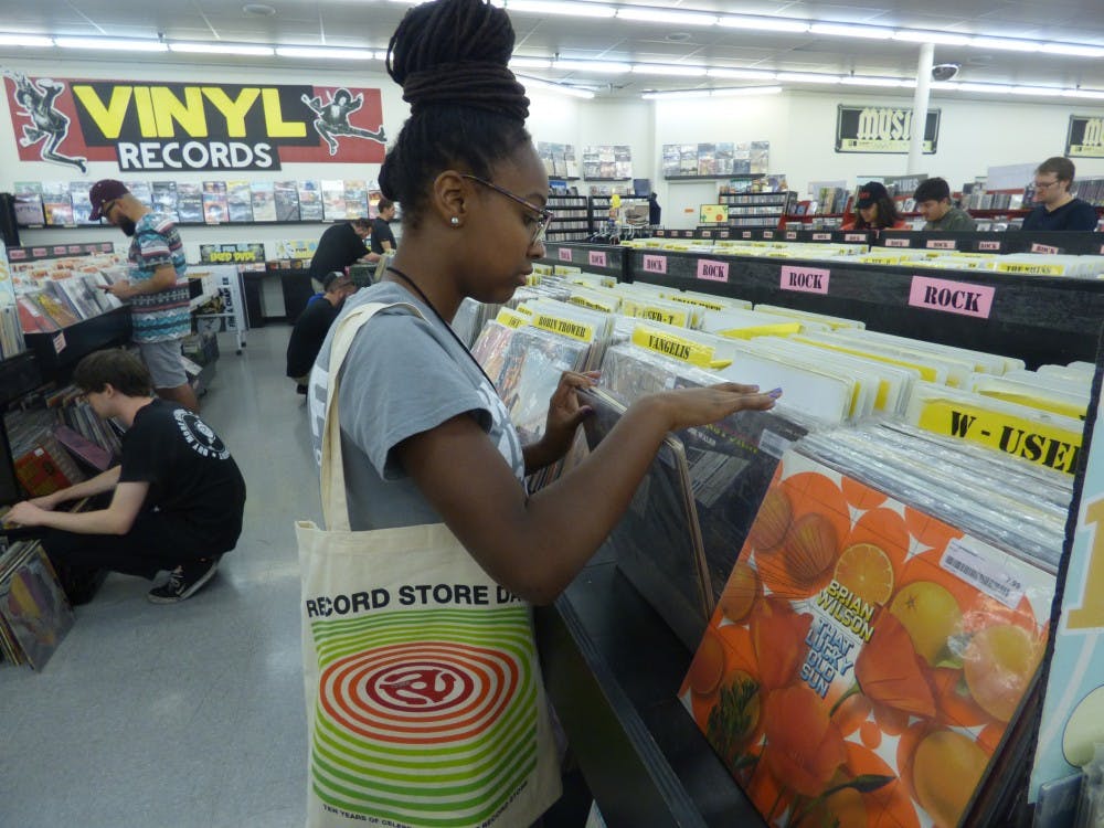 Kayla King- Summer, a sophomore journalism major, flips through vinyls on record store day, April 22, 2017.&nbsp;