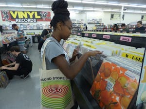 Kayla King- Summer, a sophomore journalism major, flips through vinyls on record store day, April 22, 2017.&nbsp;