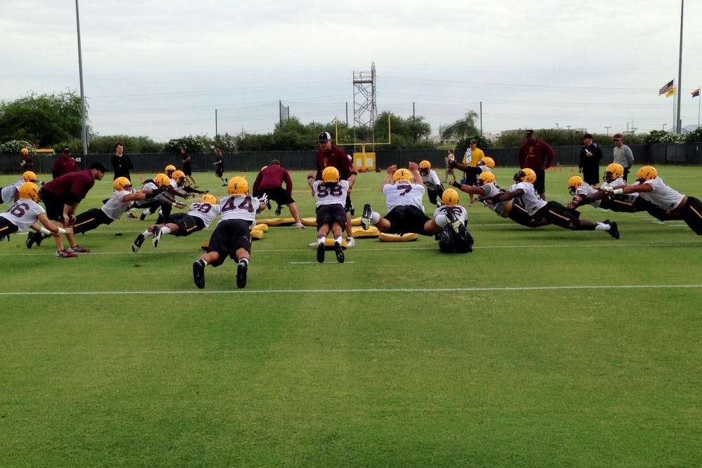 Defenders practice quick transitions at the first ASU football fall practice on Aug. 1, 2014. (Photo by Logan Newman)