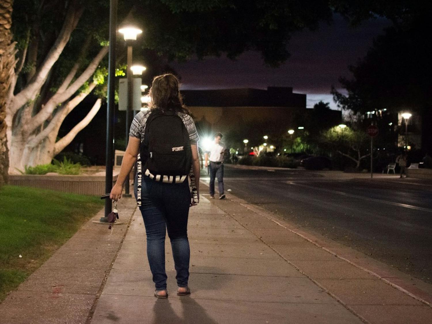 Photo illustration taken on Monday, April 17, 2017 depicting a female student walking alone at night holding pepper spray.