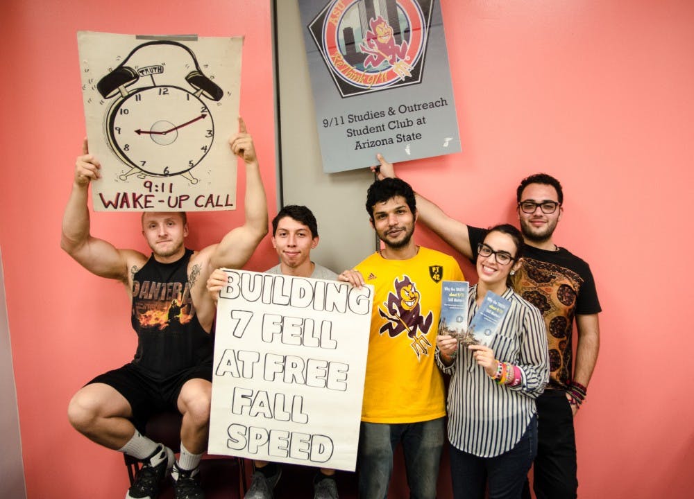 The ASU 9/11 Studies and Outreach Club is pictured on Oct. 26, 2016 holding up the signs they used at the homecoming parade. The group seeks to teach students about alternate theories surrounding the 9/11 attacks.