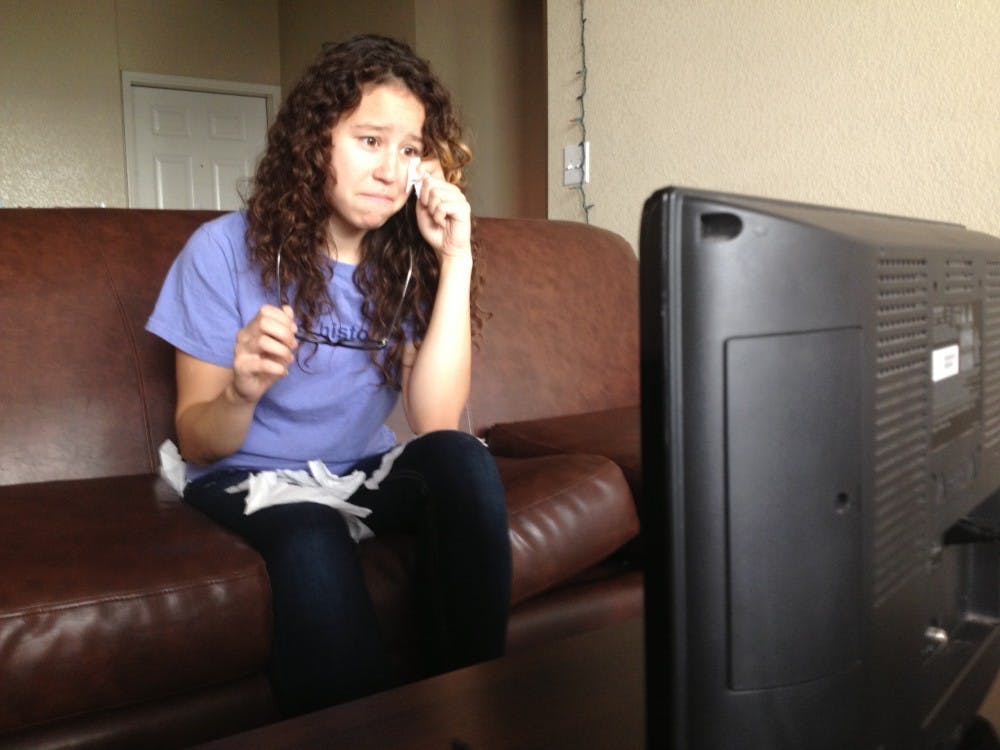 Holly sobbing as she watches some guy on "Pawn Stars" handle a 100 year old rare book with no gloves. Photo by Tom Black