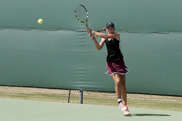 Kassidy Jump, Fr., with a forehand.