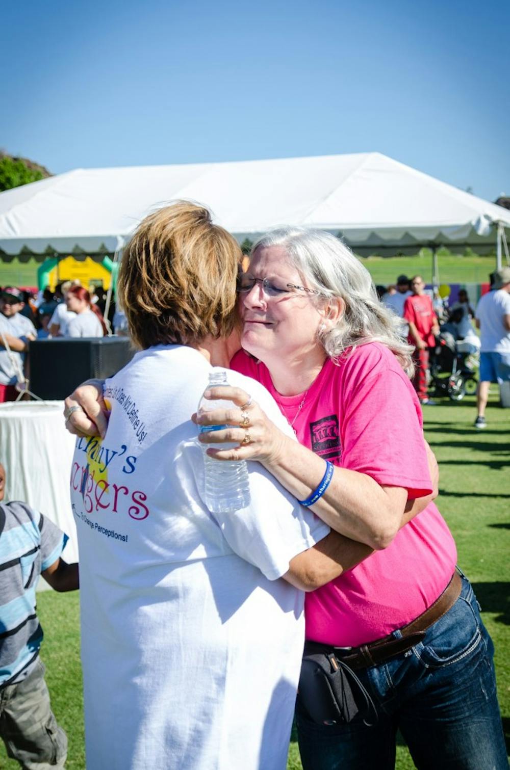 Gina Johnson, the founder of Sharing Down Syndrome Arizona, takes a moment to hug a supporter at the 14th Annual Walk for Down Syndrome. (Photo by Andrew Ybanez)