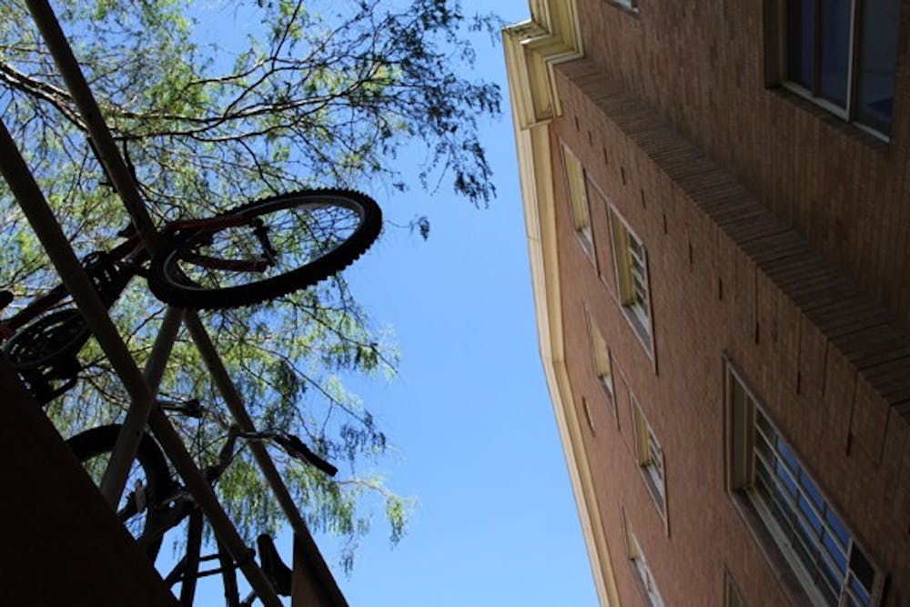 SUSPENDING BIKES: Bikes hang over the rails outside of Matthews Hall in Tempe last Wednesday afternoon. (Photo by Rosie Gochnour)