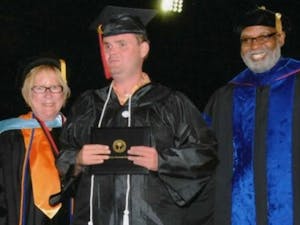 James Deibler, center, receives his associates degree in general studies from Glendale Community College. 