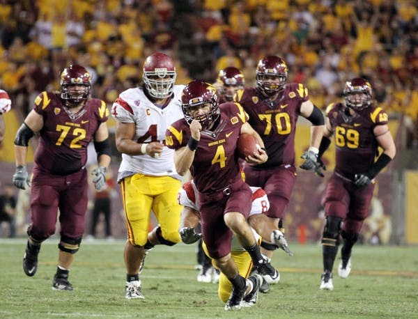 SPREADING OUT: Senior wide receiver Aaron Pflugrad (ball) outruns USC defensive end Nick Perry (8) during the Sun Devils’ 43-22 win over the Trojans. Coach Dennis Erickson said one of ASU’s strengths is the number of receivers involved on offense. (Photo by Lisa Bartoli)