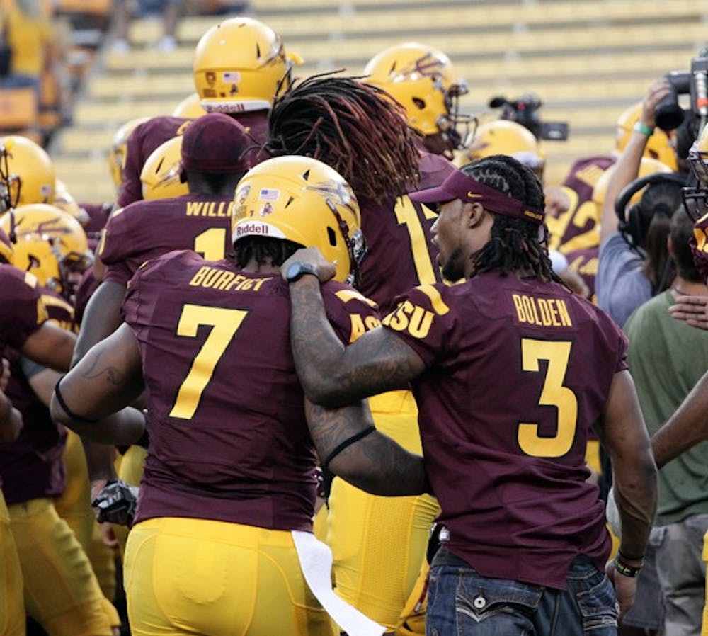 ASU senior cornerback Omar Bolden talks to junior linebacker Vontaze Burfict during the Sun Devils’ win over UC Davis in the first game of the season. Bolden hasn’t wasted his final year with the team, and is a leader despite a knee injury. (Photo by Beth Easterbrook)