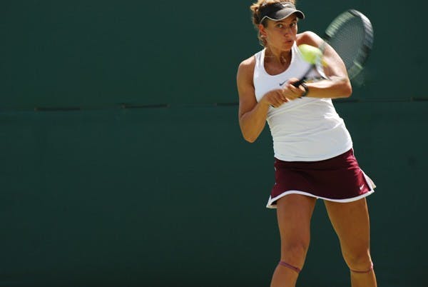 Senior Jacqueline Cako uses all her strength to return a shot against UCLA on April 6. Cako and doubles partner senior Nicole Smith need a strong performance at the Pac-12 championships to qualify for the NCAA tournament. (Photo by Murphy Bannerman)