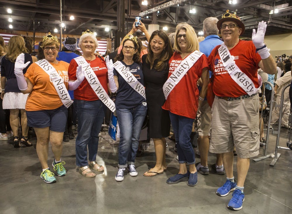 Spectators dressed as "Nasty Women" pose for a photo in the Phoenix Convention Center during a campaign stop featuring first lady Michelle Obama for Democratic presidential nominee Hillary Clinton on Thursday, Oct. 20, 2016. 