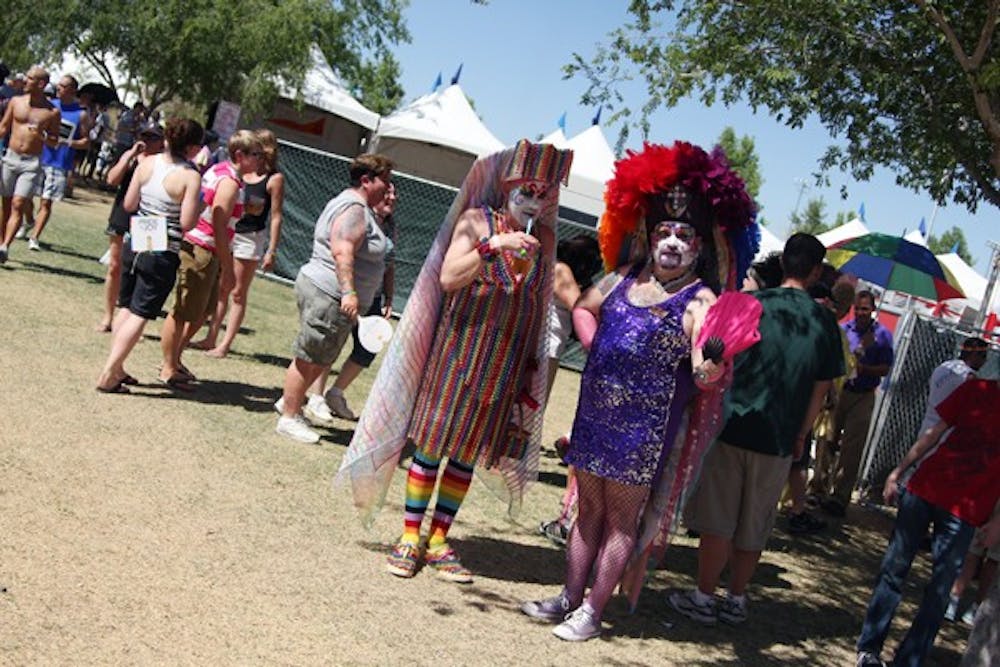 Two festivalgoers, who identified themselves as Sister Jinger Bread Mann, left, and Sister Bearie, right, wander around the Phoenix Pride festival Saturday afternoon at Steele Indian School Park. (Photo by Jenn Allen)