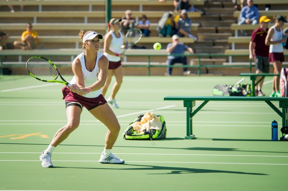 Desirae Krawczyk swats the ball to continue the double's rally during the match against  the Princeton Tigers on Thursday, Jan. 28, 2016 at Whiteman Tennis  Center in Tempe, AZ. (J.Bauer-Leffler/The State Press)