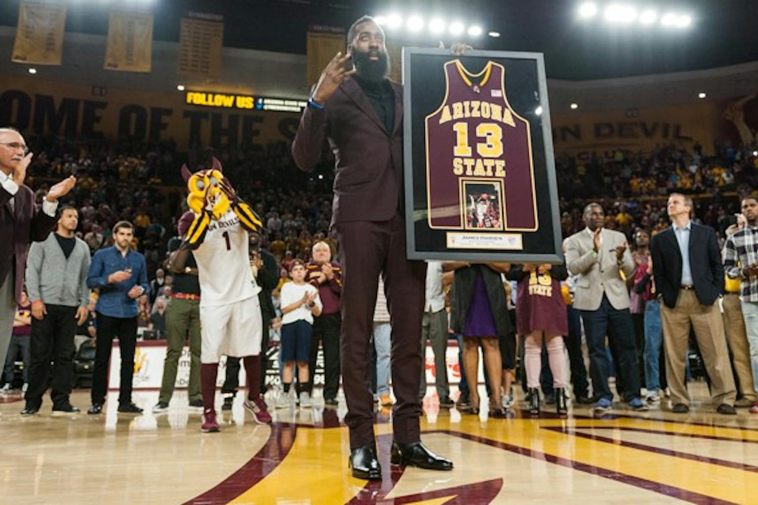 Houston Rockets shooting guard James Harden displays an award on Wednesday, Feb. 18, 2015, at Wells Fargo Arena in Tempe. Harden, a former ASU basketball standout, was honored at halftime for his achievements both with the Sun Devils and in the NBA. (Ben Moffat/The State Press)